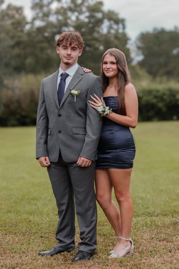 Young couple dressed formally for a special event outdoors.
