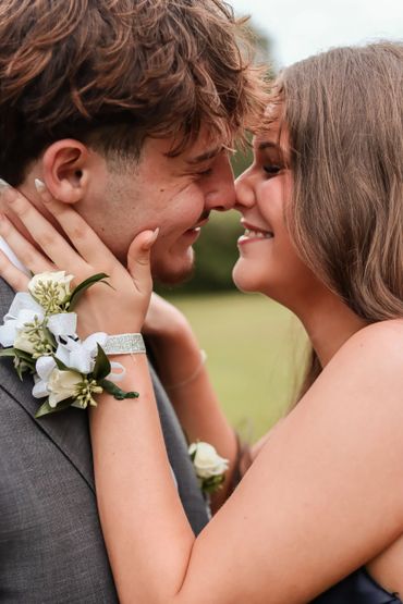 Young couple sharing an intimate moment, smiling and about to kiss.