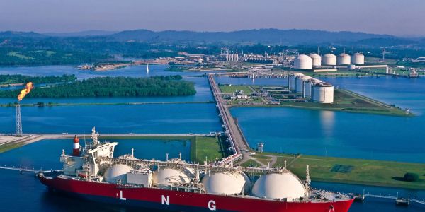 A large LNG tanker docked at a liquefied natural gas terminal.