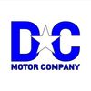 Logo of DC Motor Company with a bold blue design and a prominent star.
