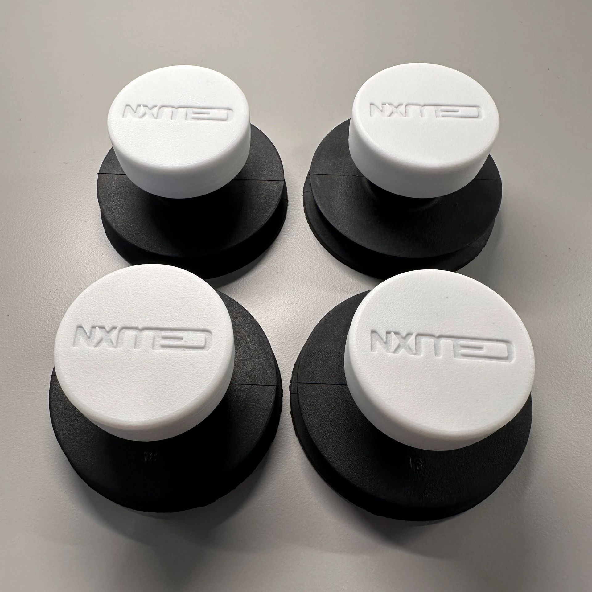 Four black and white circular objects with the text 'CLIMX' on top.