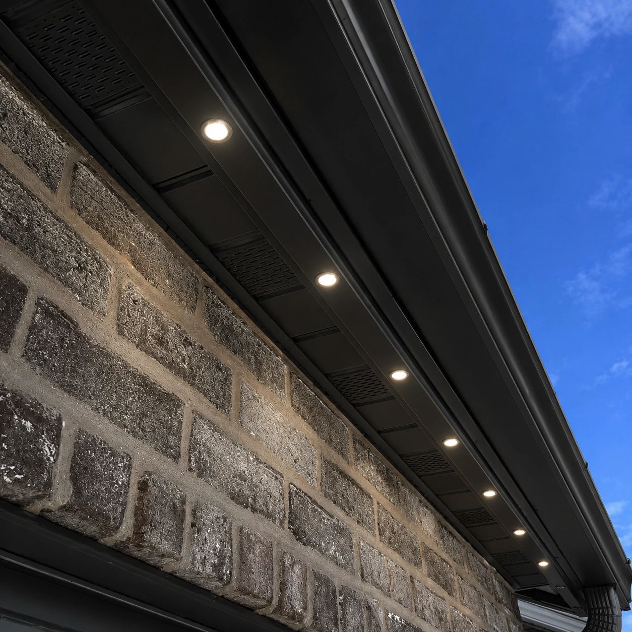 AUREA 16 low-profile roofline light installed in a color-matched soffit track.