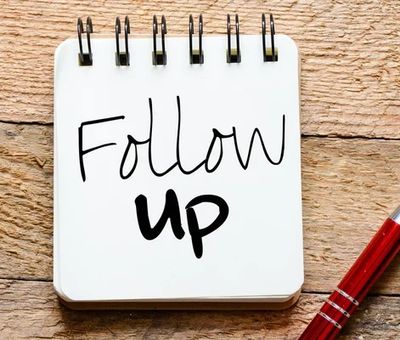 Notebook with 'Follow up' written and a red pen beside it.