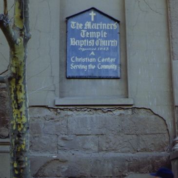 Signboard of Mariners Temple Baptist Church on a weathered wall.
