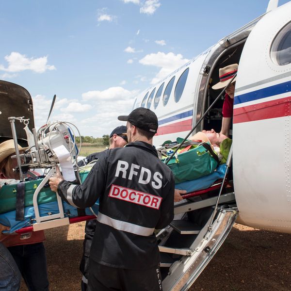 RFDS Doctor loading patient on plane