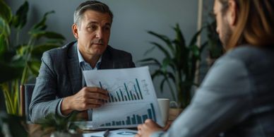 Businessman explaining financial charts during a meeting.