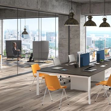 Modern office space with large windows and orange chairs.
