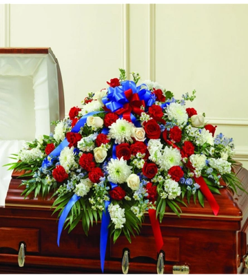 Floral arrangement atop a coffin.