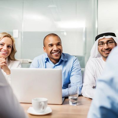 a group of businesspeople one in traditional Arab kandura