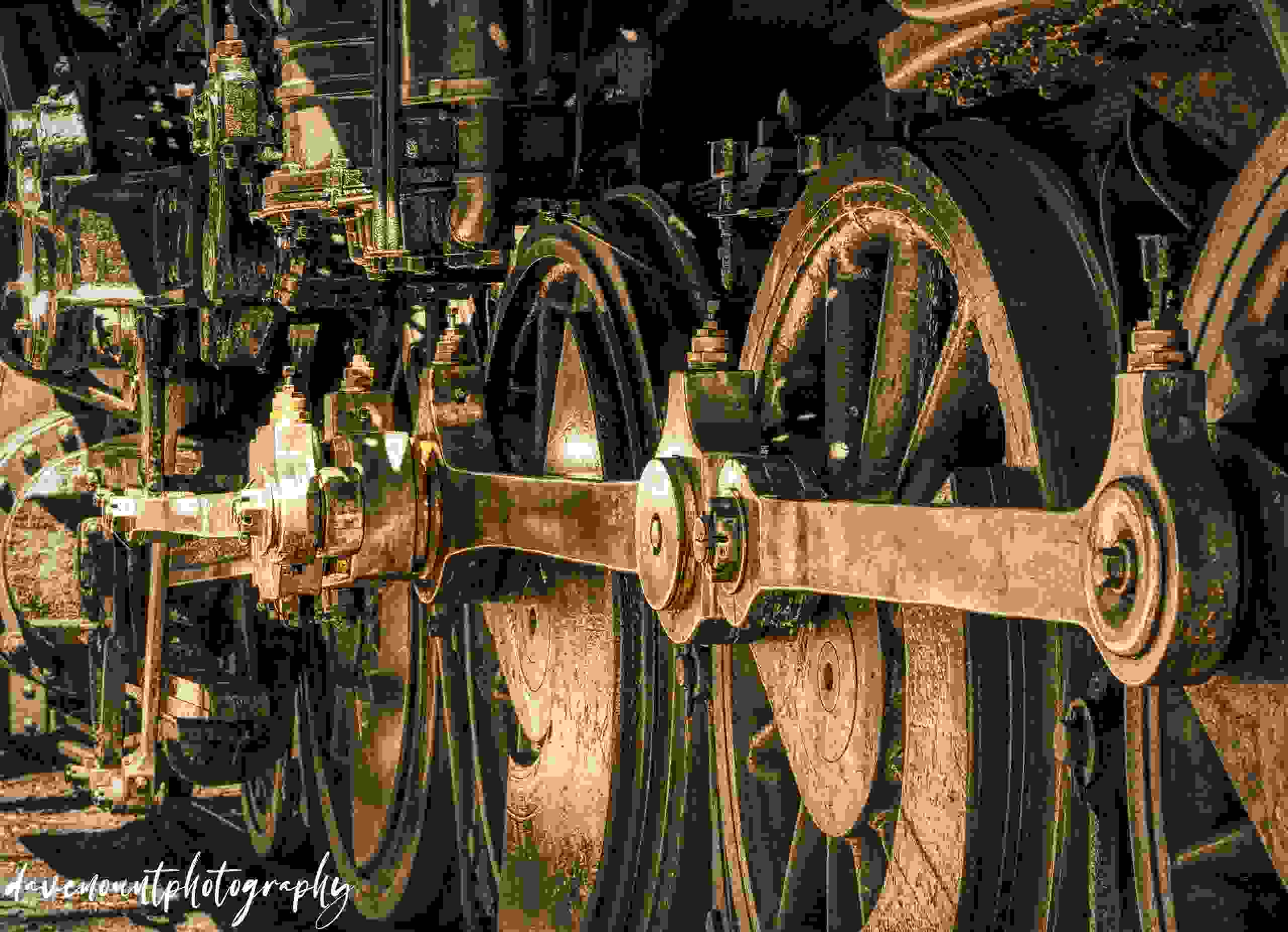 Golden-toned monochrome of steam engine running gear at Strasburg Railroad, July 201