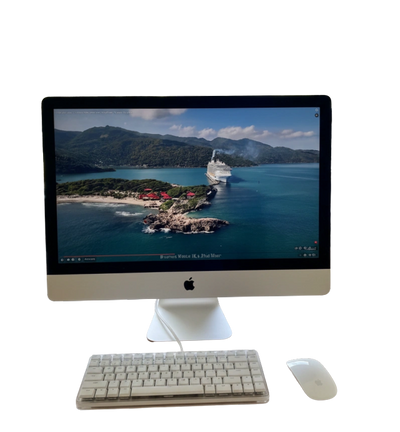 Apple iMac with keyboard and mouse displaying a scenic island and cruise ship.