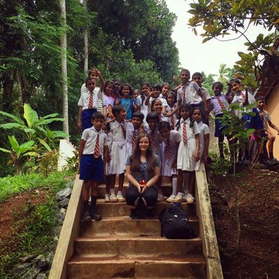 A woman with a group of kids in her back.