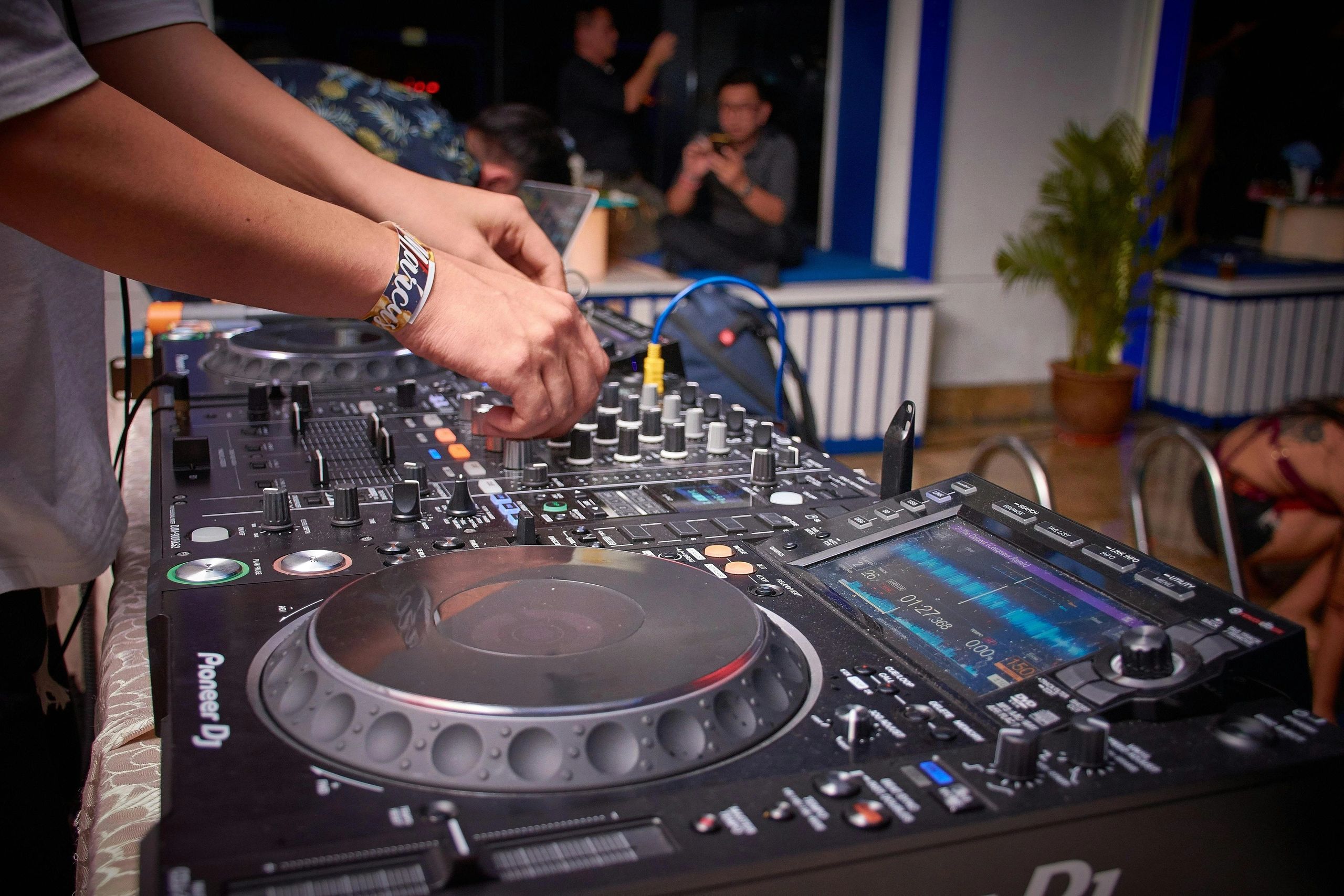 DJ mixing on Pioneer deck at a South Florida event