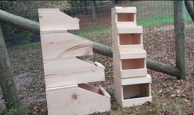 Wooden stacked nesting boxes outside.