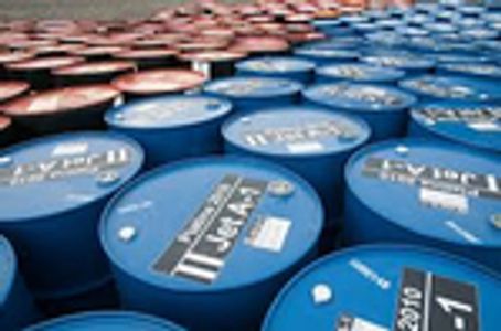 Rows of blue and red industrial barrels tightly packed outdoors.