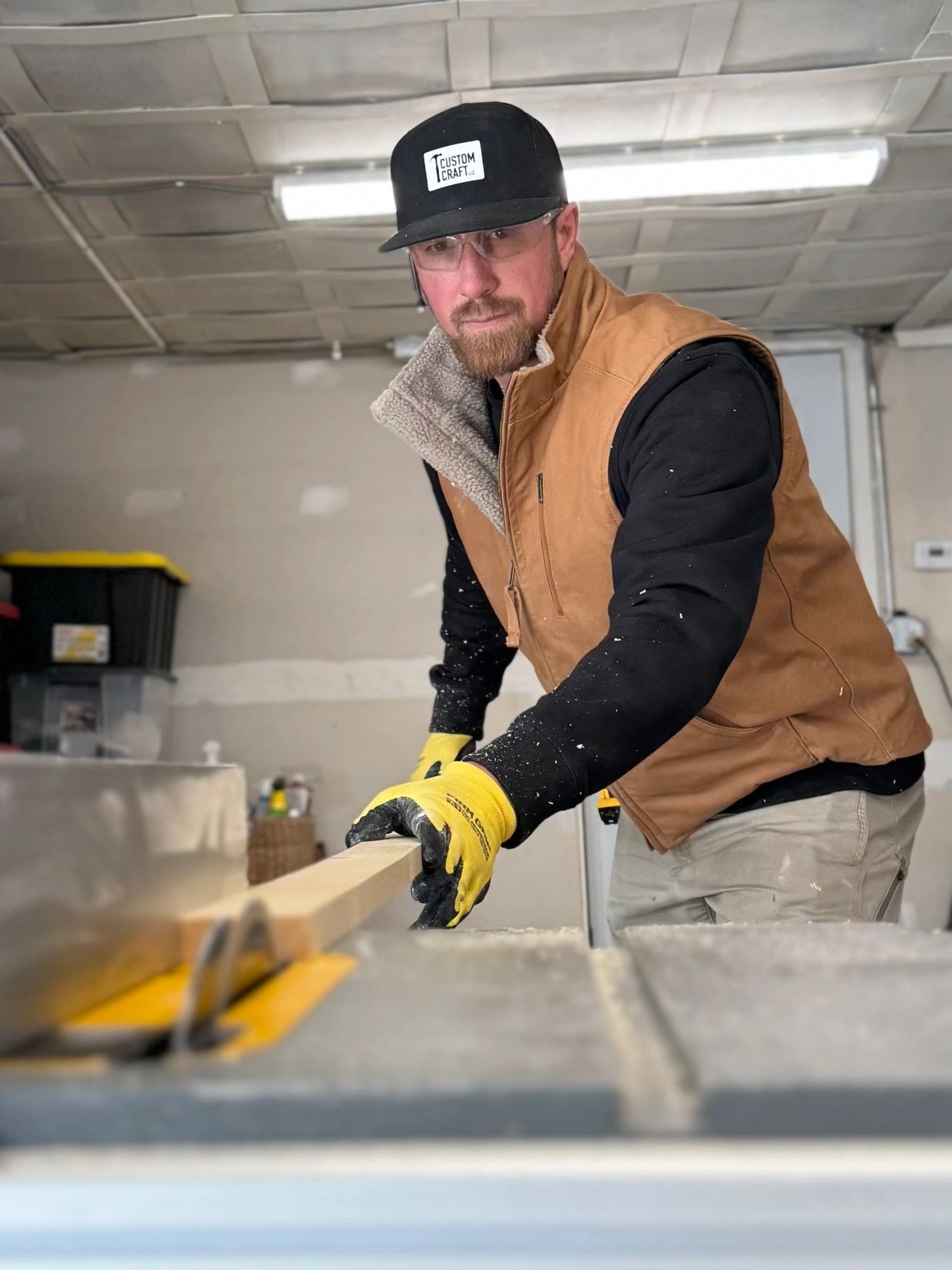 Man cutting wood with protective gear.
