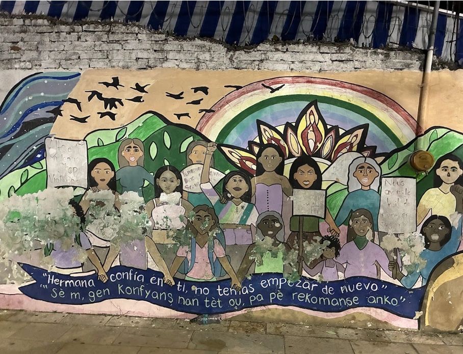 A Mural in Spanish and Haitian Creole reads: “Sister, believe in yourself, don’t be afraid to start again.” 