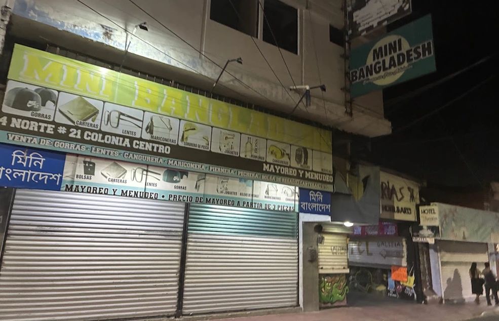 A store called “Mini Bangladesh” near downtown Tapachula advertises wholesale and retail sales of various items, including hats, purses, glasses, and toys.     