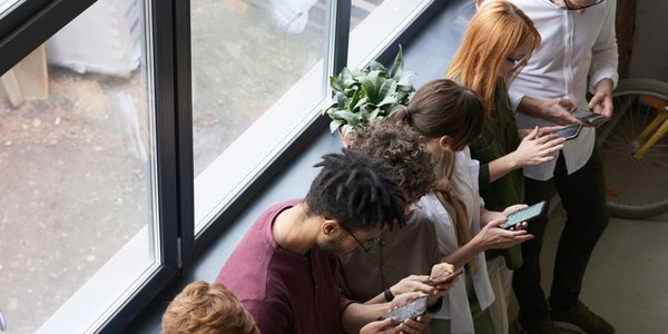 Group of people working on their phone