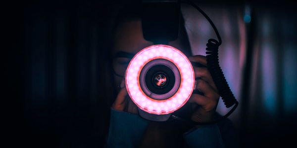A camera taking a picture with purple lighting