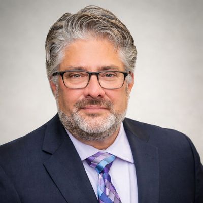 Professional man in glasses wearing a suit and tie.