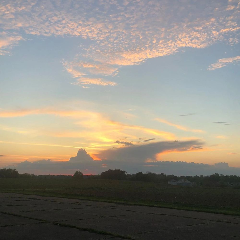Farm field overlooking a summer sunset
