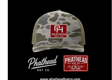 Camouflage Phathead Hat Co. cap with logo and text.