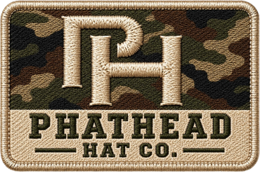 Embroidered PH logo patch on camouflage background.