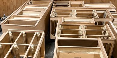Wooden cabinet frames organized in a workshop.