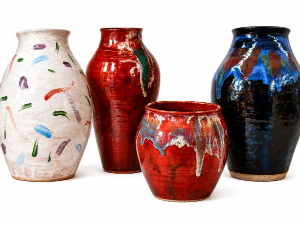 Four colorful glazed ceramic pots.