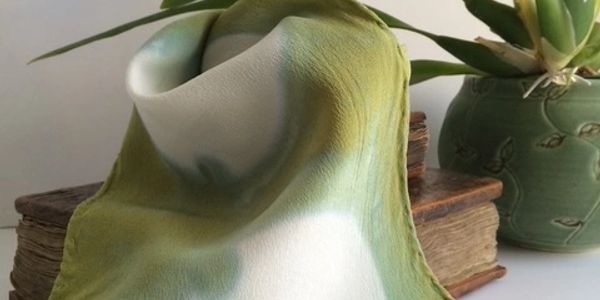 Soft green and white fabric draped over books.