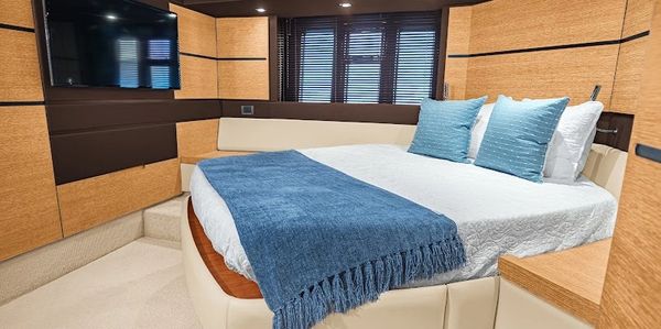 Cozy bedroom with blue accents and wooden paneling.