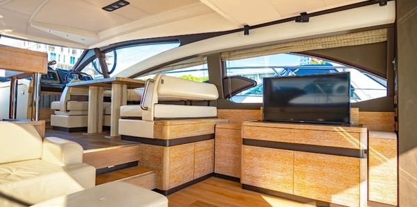 Luxurious yacht interior with wooden finishes and modern seating.