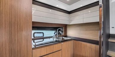 Modern kitchen with wooden cabinets and a sleek black countertop.