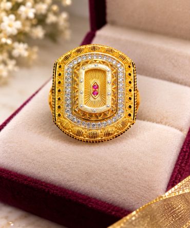 Ornate gold ring with gemstones in a jewelry box.