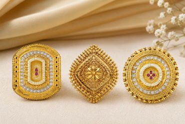 Three ornate gold rings with diamonds and rubies.