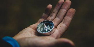 A hand with a compass in its palm