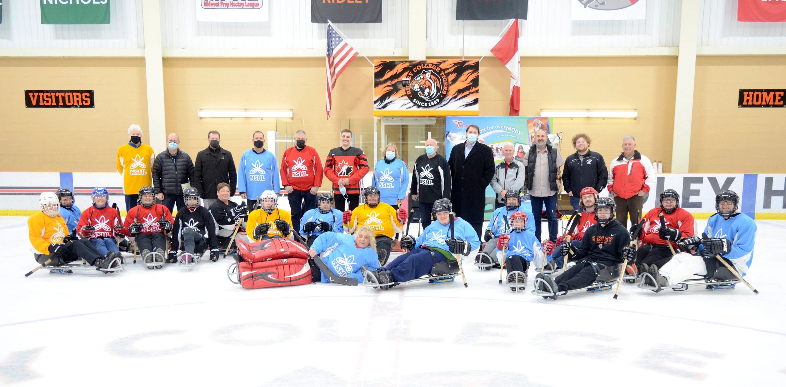 The players of the Niagara Sledge Hockey League posing with the Mayors from Niagara at the Puck Drop