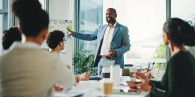 Man leading a business presentation to a diverse group.