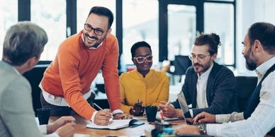 Diverse team collaborating in a bright office meeting room.