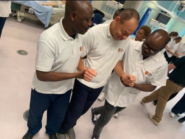 Three men holding hands and supporting each other.