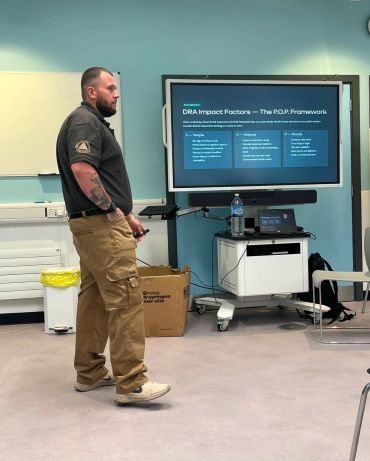 Man giving a presentation in a classroom.