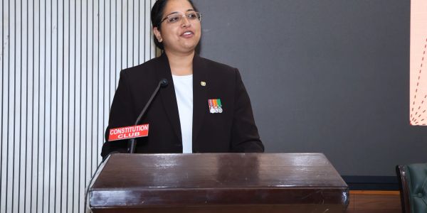 A woman speaking at Constitution Club podium.