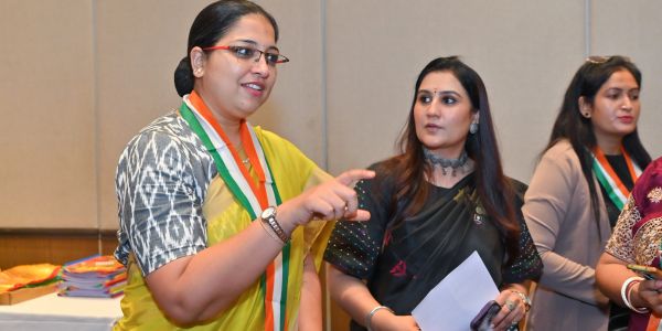 Women engaged in a discussion at an event.