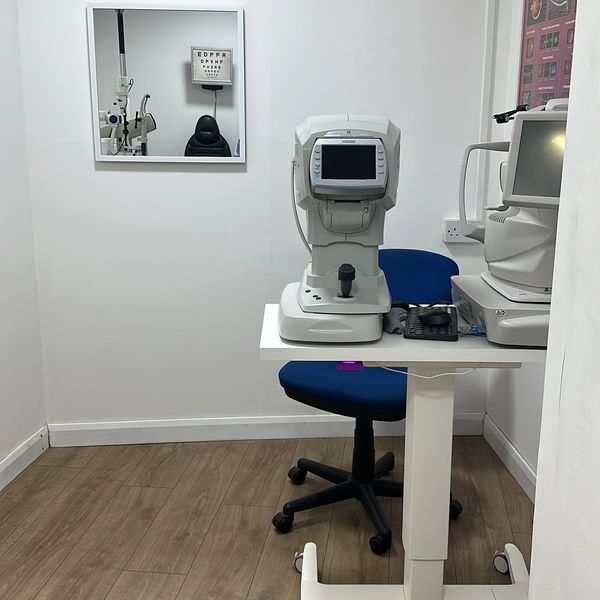 Eye exam room with diagnostic equipment.