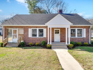 Single-story brick house with white trim and front porch.