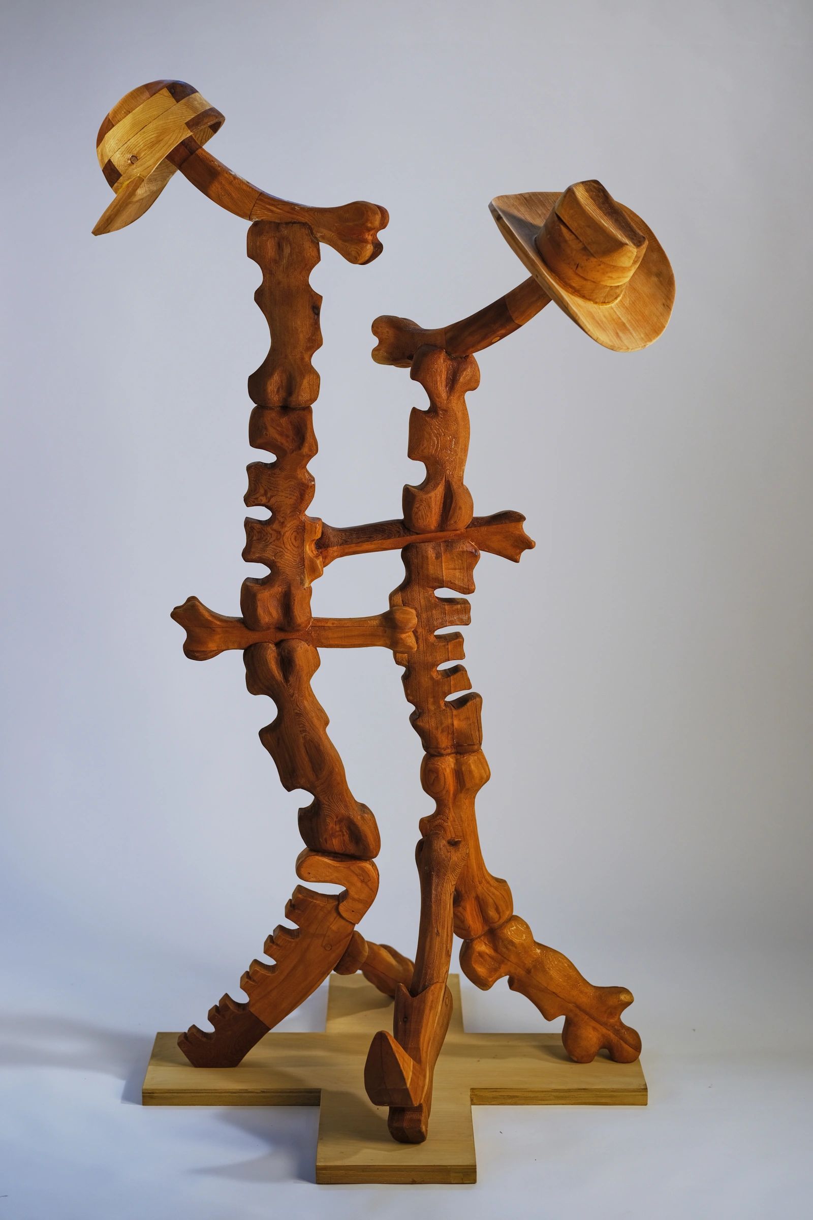 Large scale wood sculpture depicting an abstract carpenter and cowboy. 