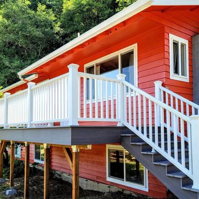 Gray Trex deck with white railing, on a bright red house.
#deck #deckbuilder #generalcontractor