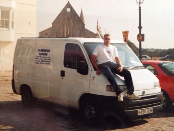 Tom Case sitting on his first ever Casewood Floors Van circa year 2000