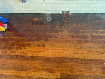 Polish and dirt built up around the edges of the hardwood floor